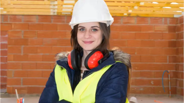 Woman wearing a white hard hat and yellow hi-vis jacket