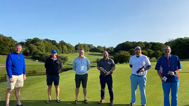 Men standing on a golf green