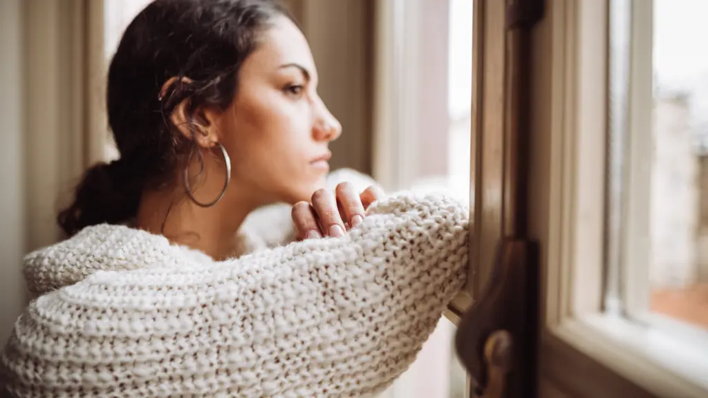 Woman Looking Out Of Window