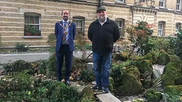 Mayor and man in garden