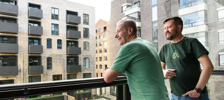 Men looking out of a balcony