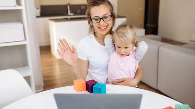 Woman and child looking at a laptop