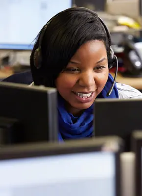 Woman with headphone in front of computer